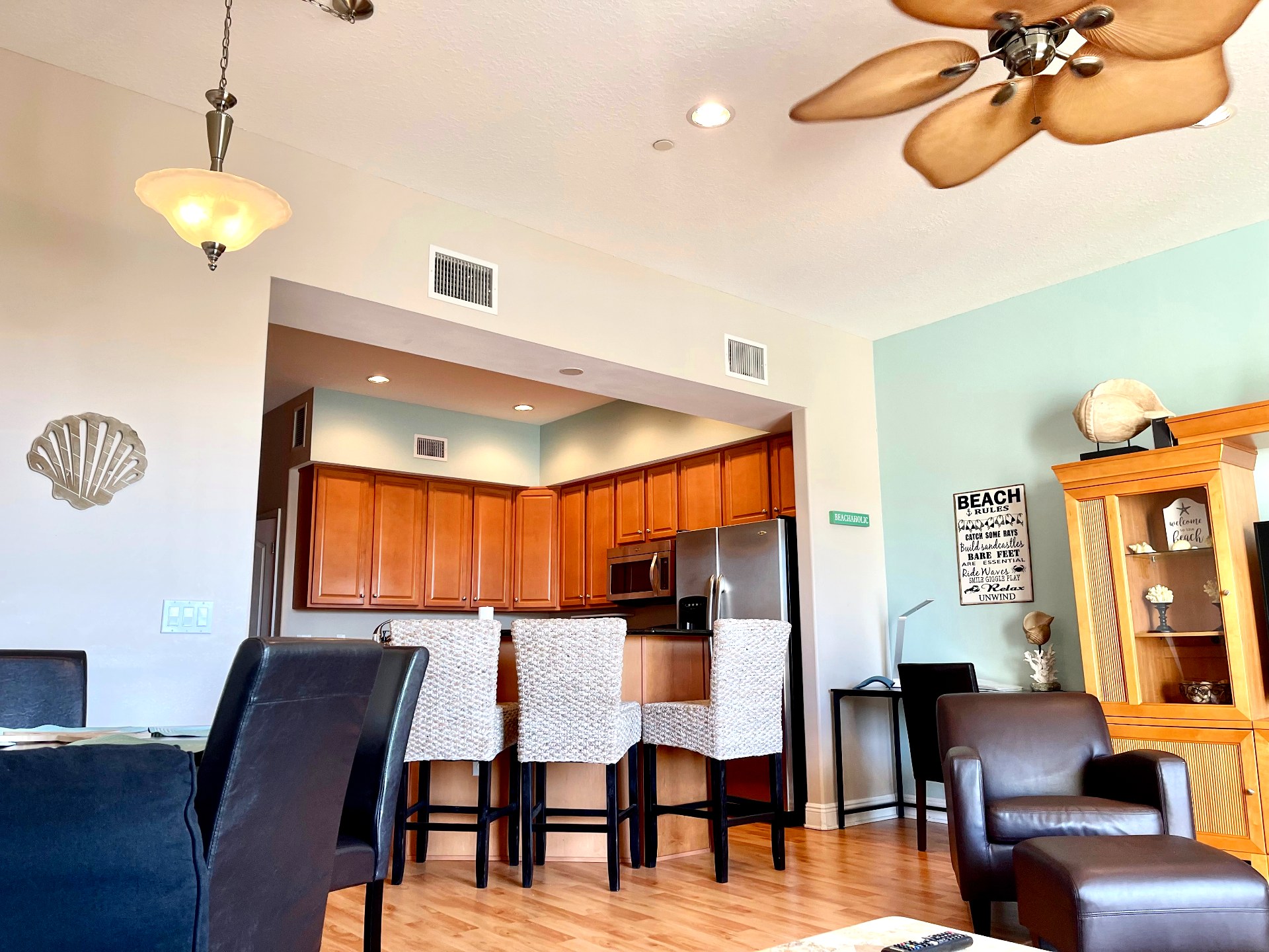 Open living and kitchen with breakfast bar and coastal decor