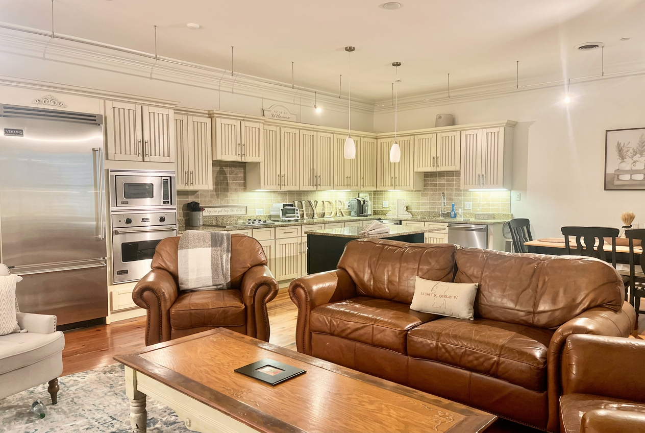 Open kitchen with Viking appliances flowing into the leather living area and dining table